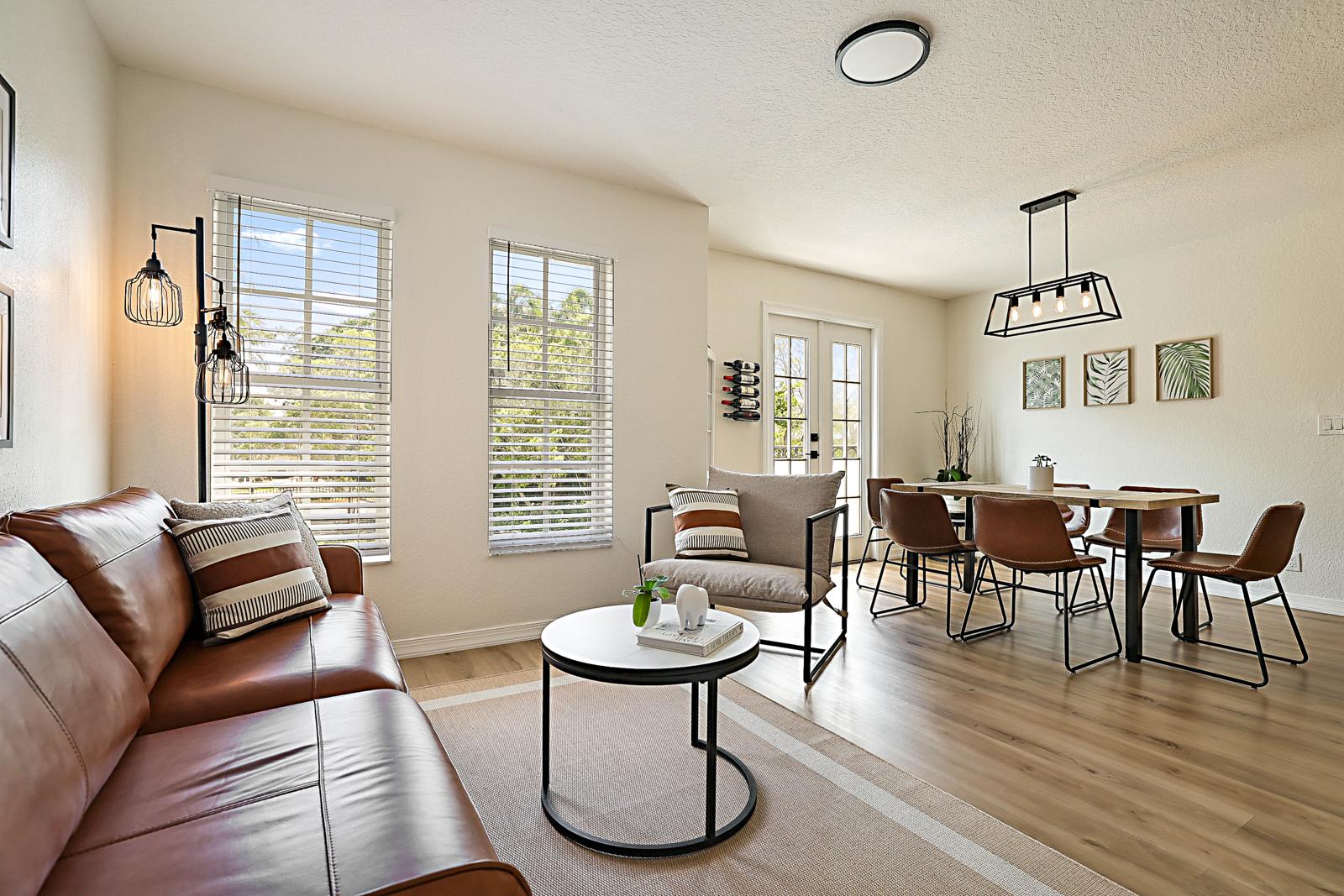 1105 Lake Shore Drive #205, Lake Park, FL 33403 - open living and dining area with luxury vinyl plank floors
