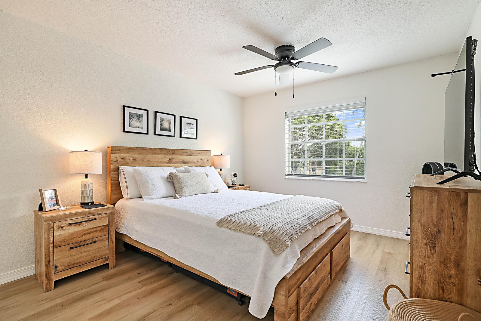 1105 Lake Shore Drive #205, Lake Park, FL 33403 - bedroom with ceiling fan and window