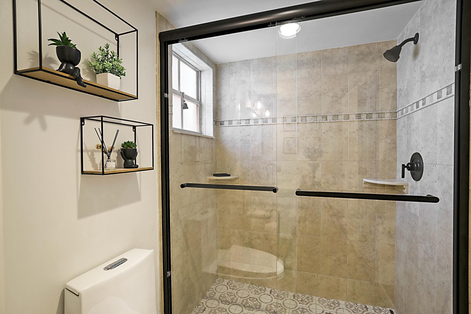 1105 Lake Shore Drive #205, Lake Park, FL 33403 - walk-in glass shower with tile surround