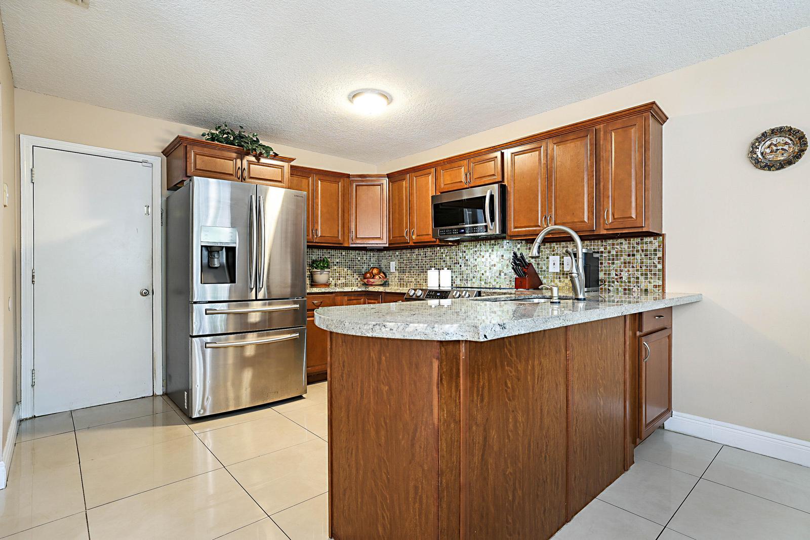 6666 Saltaire Terrace, Margate, FL 33063 - kitchen with island and stainless steel appliances