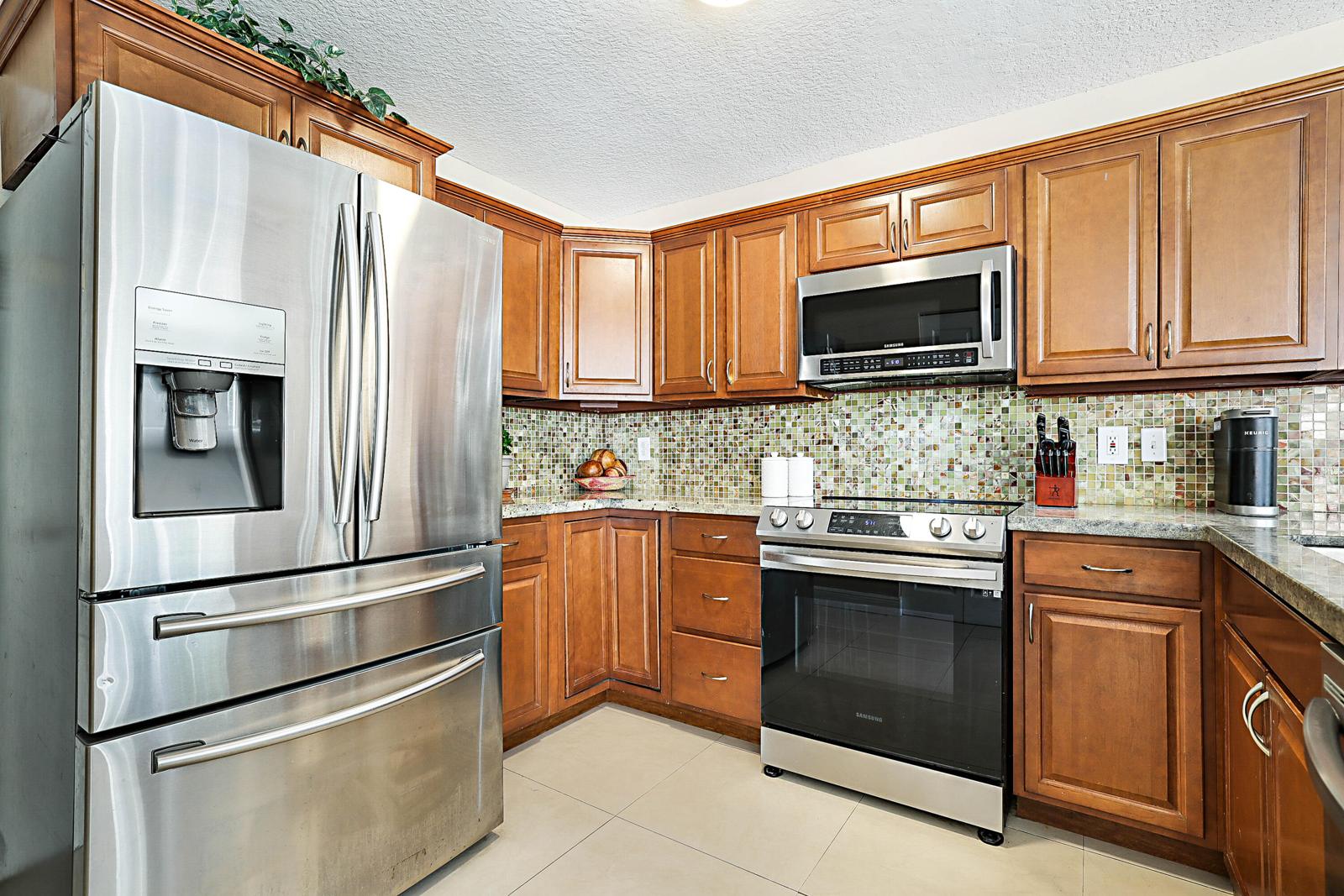 6666 Saltaire Terrace, Margate, FL 33063 - kitchen with wood cabinets and granite counters