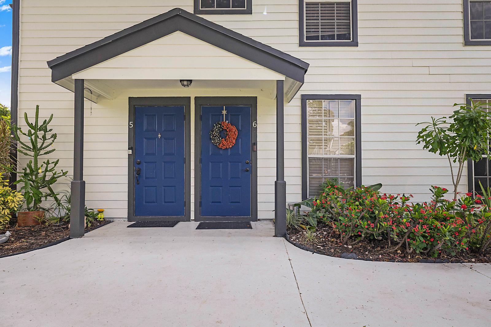 5032 Heatherhill Lane #6, Boca Raton, FL 33486 - covered entry with blue front door at 5032 Heatherhill Lane #6