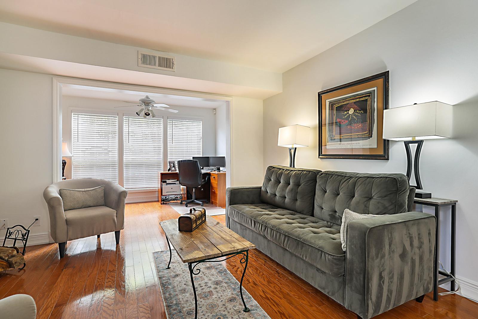 5032 Heatherhill Lane #6, Boca Raton, FL 33486 - living room with hardwood floors and sliding door to the patio