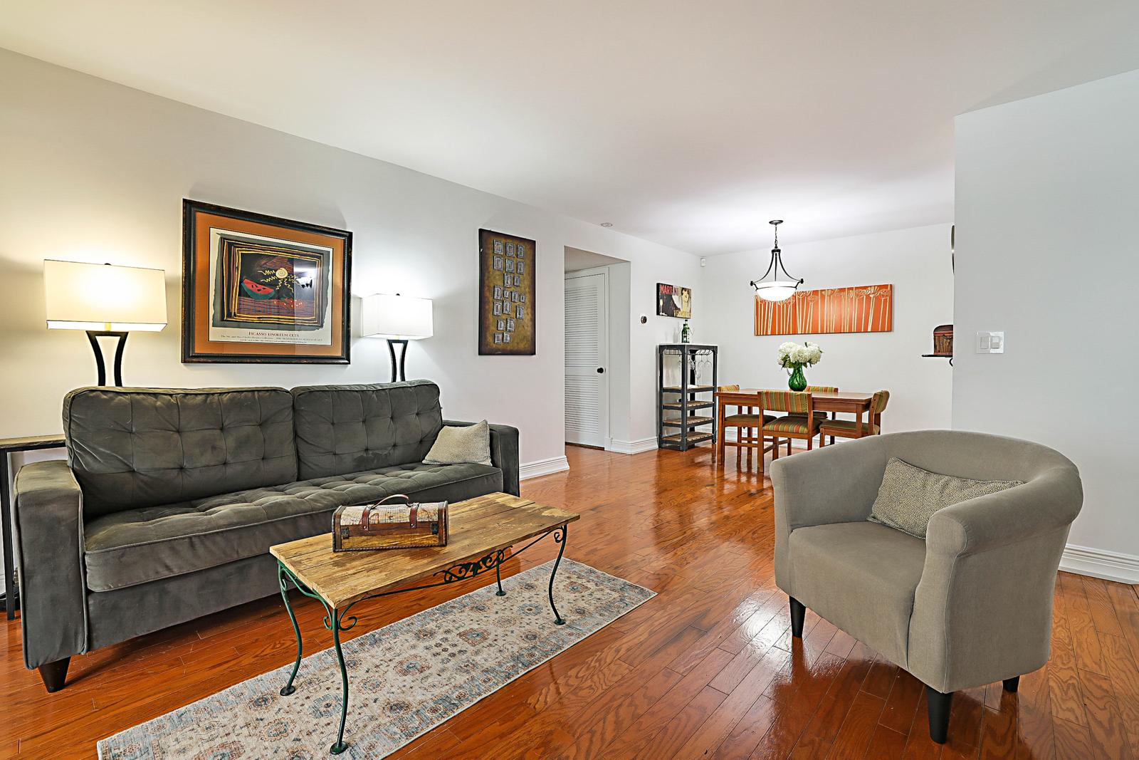 5032 Heatherhill Lane #6, Boca Raton, FL 33486 - living room with stone fireplace open to the dining area