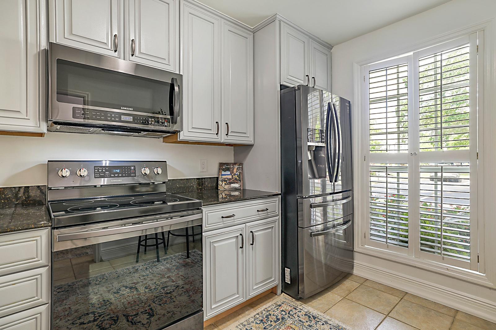 5032 Heatherhill Lane #6, Boca Raton, FL 33486 - kitchen with plantation shutters and French-door refrigerator