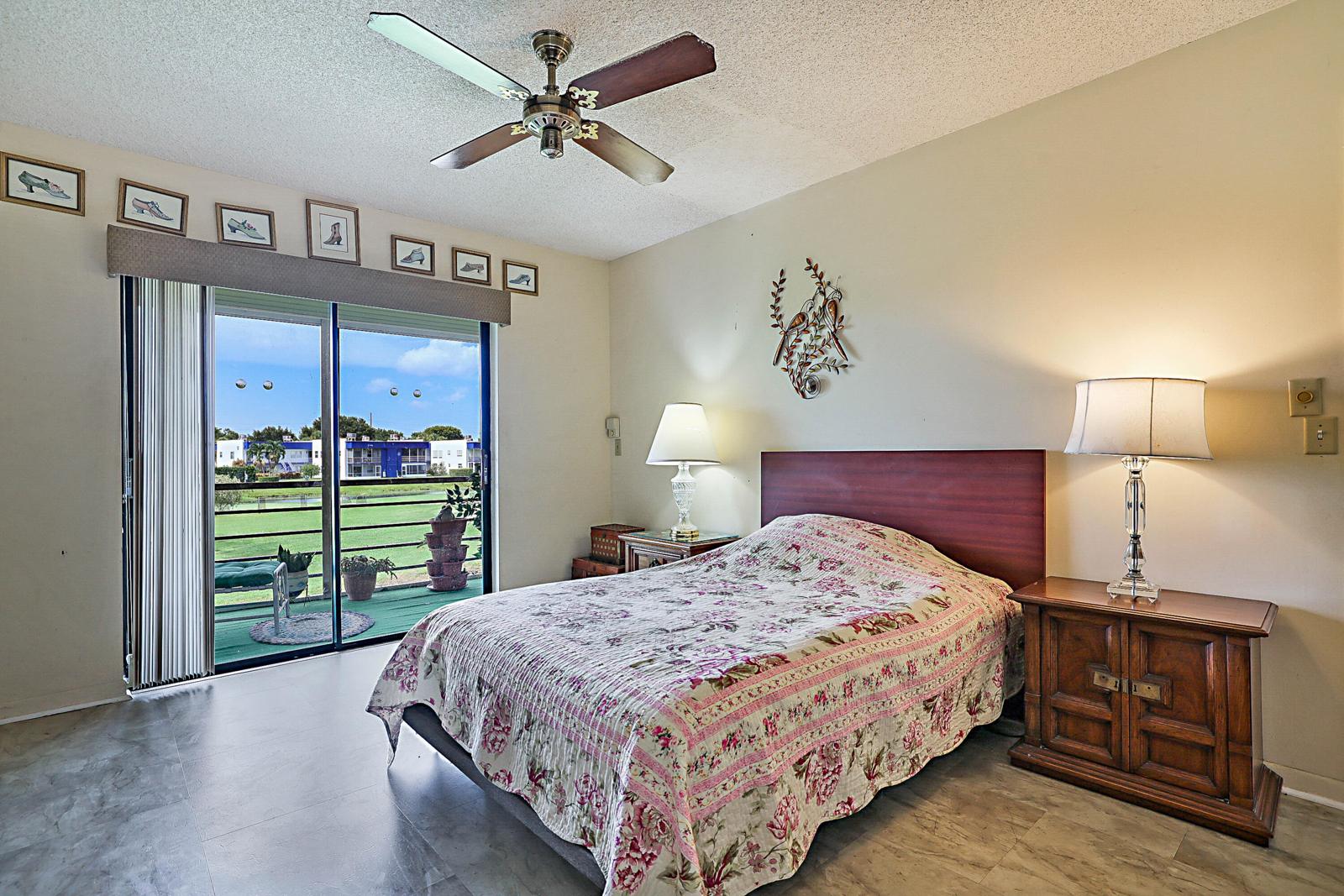 76 Capri B, Delray Beach, FL 33484 - primary bedroom with sliding doors to the balcony