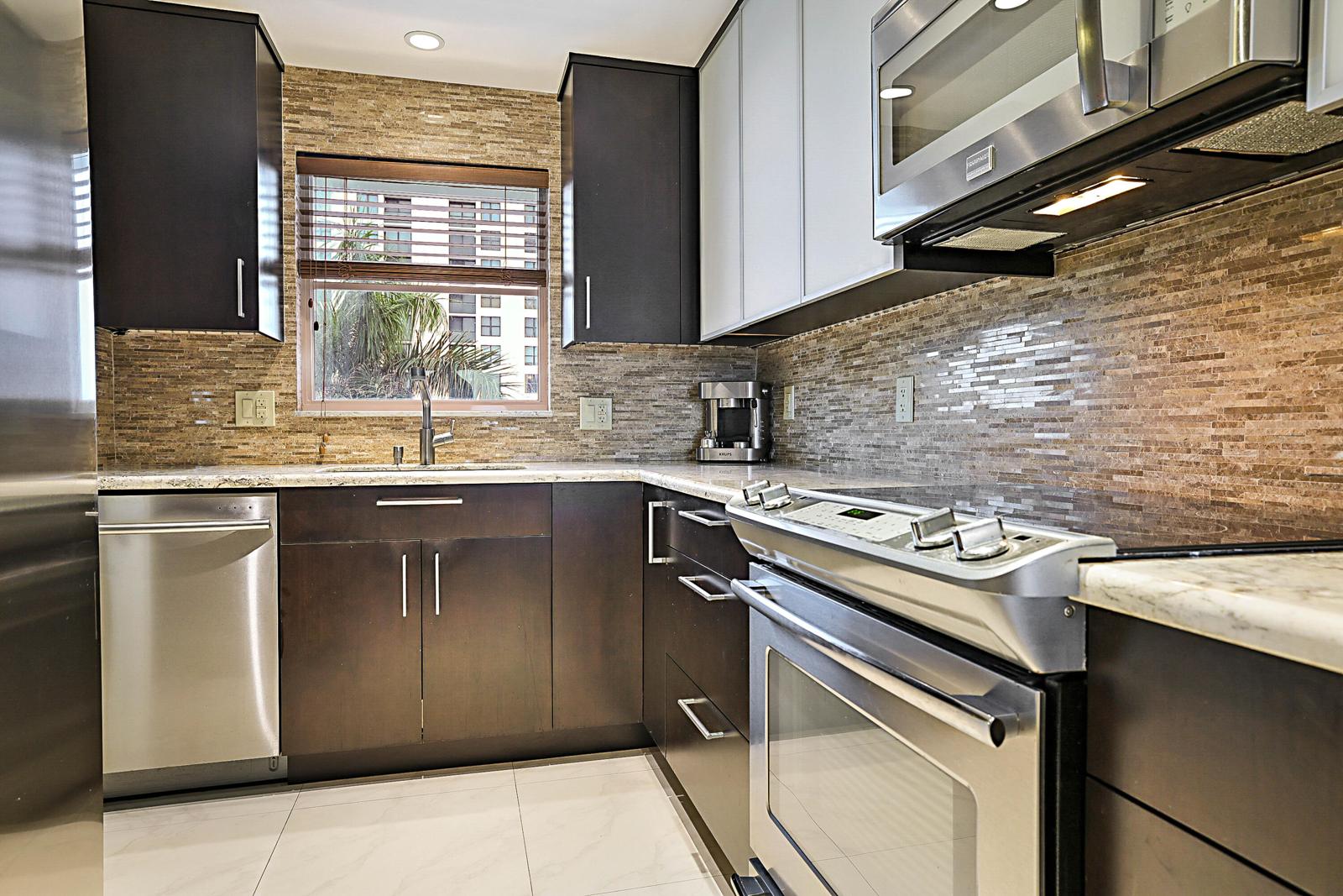 3114 S Ocean Boulevard #509, Highland Beach, FL 33487 - kitchen with granite counters and stainless range